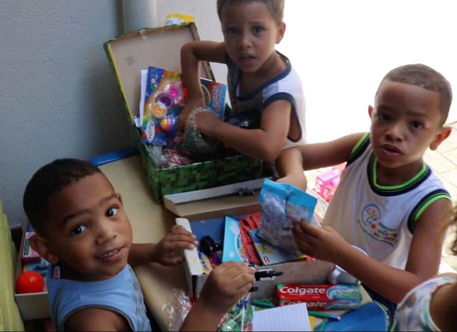 children opening Christmas gifts shoe box