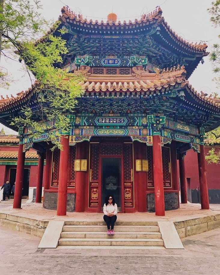 temple black woman sitting on stairs in beijing