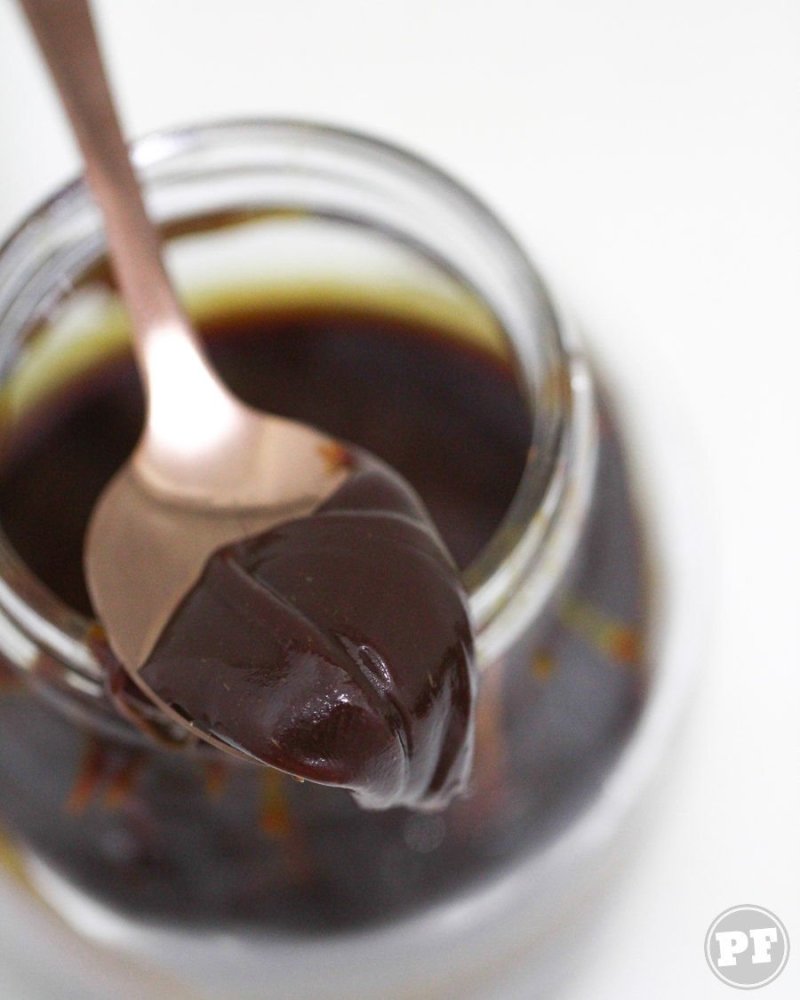 Umami caramel on a spoon in a jar highlighted