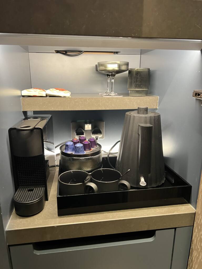 Minibar with coffee maker and capsules at The Londoner Hotel, London, West End