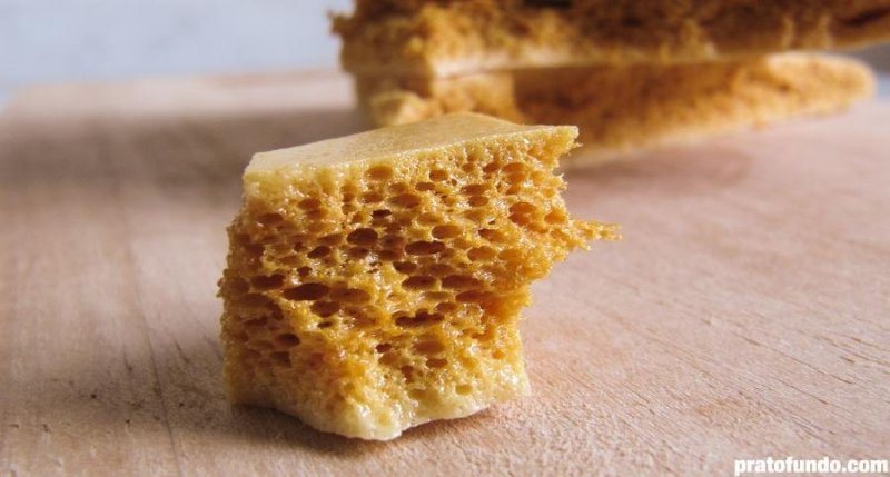 Piece of Honeycomb Candy in detail on a wooden board