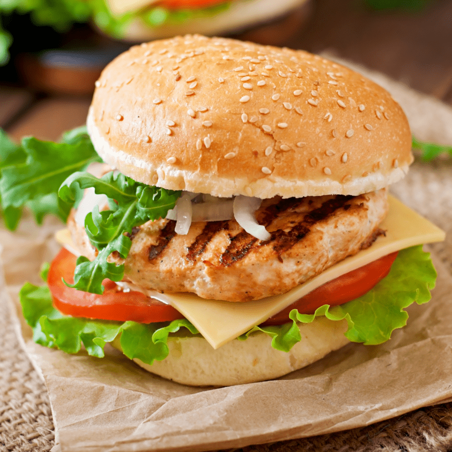 An air-fried chicken burger on brown paper