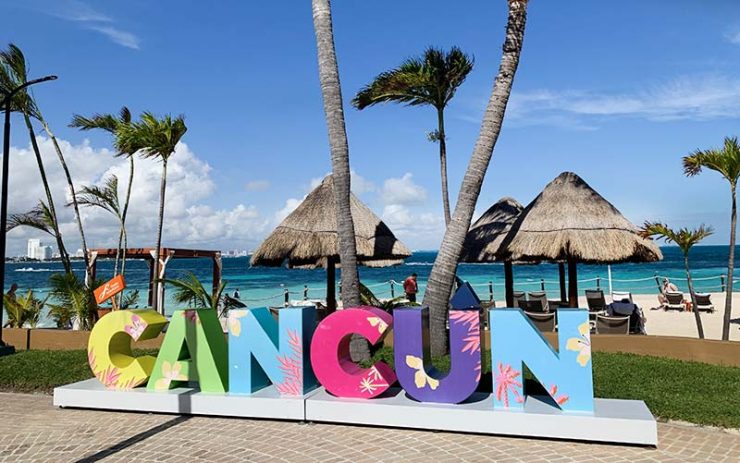 Cancún sign and sea in the background