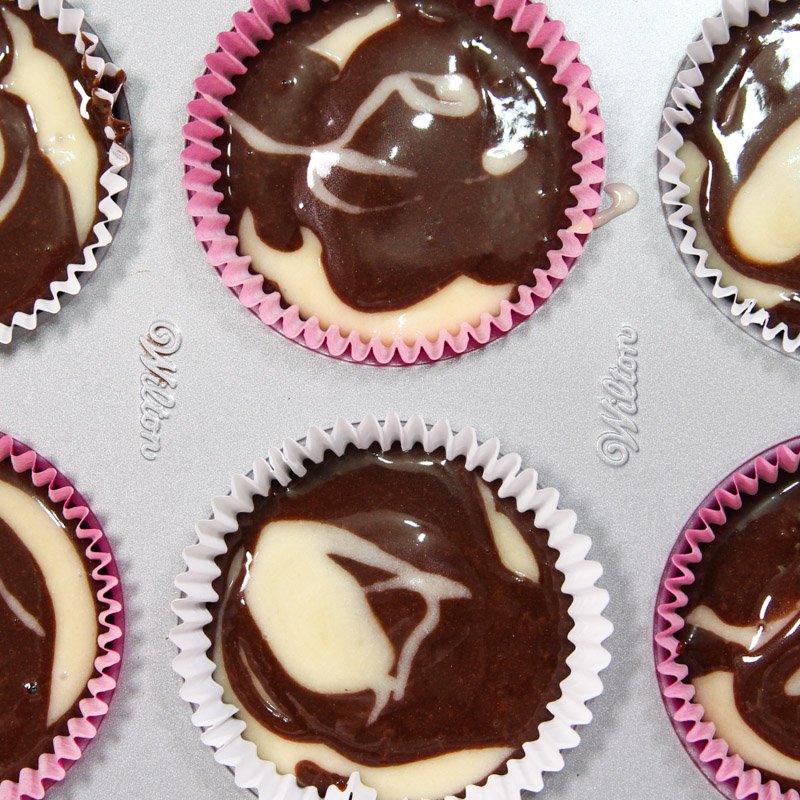 Raw cupcake batter seen close up in the pan