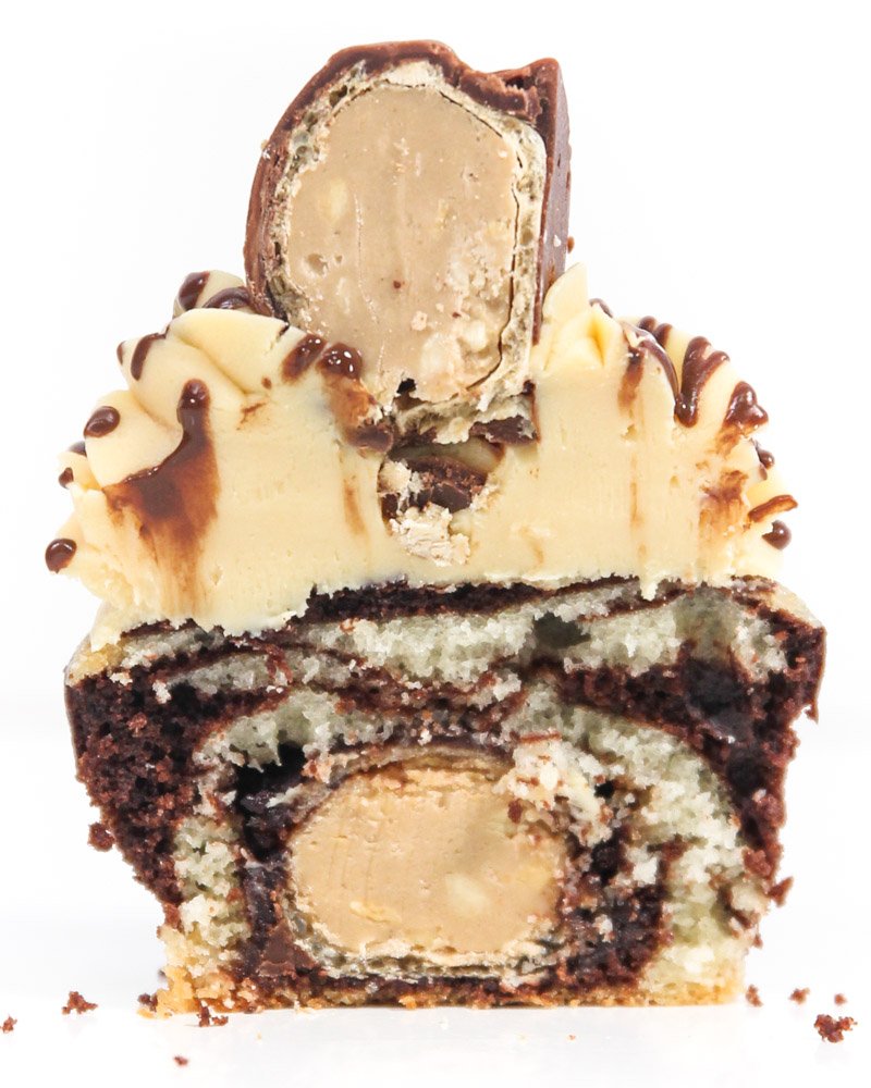 Cupcake cut in half showing peanut candy filling