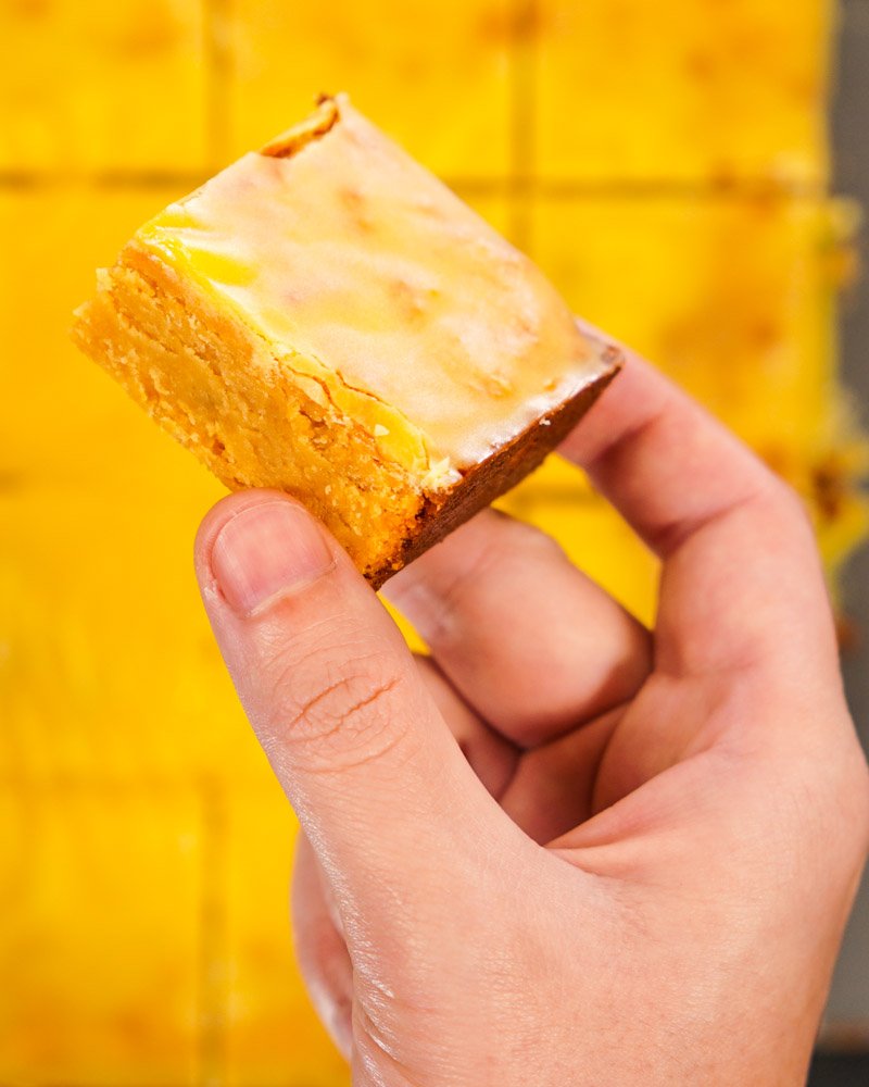 Male hand holding a piece of Bergamot (or Tangerine or Tangerine) Brownie