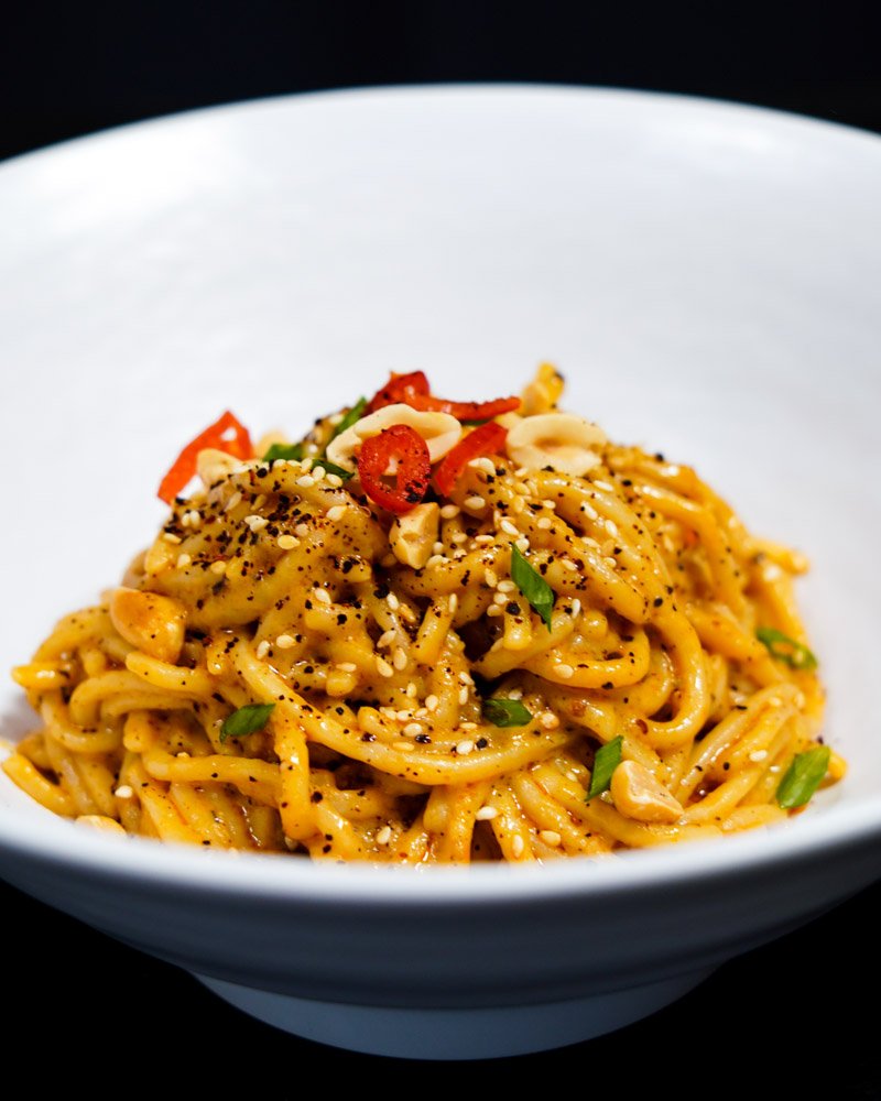 Noodles with Asian flavors in a bowl.