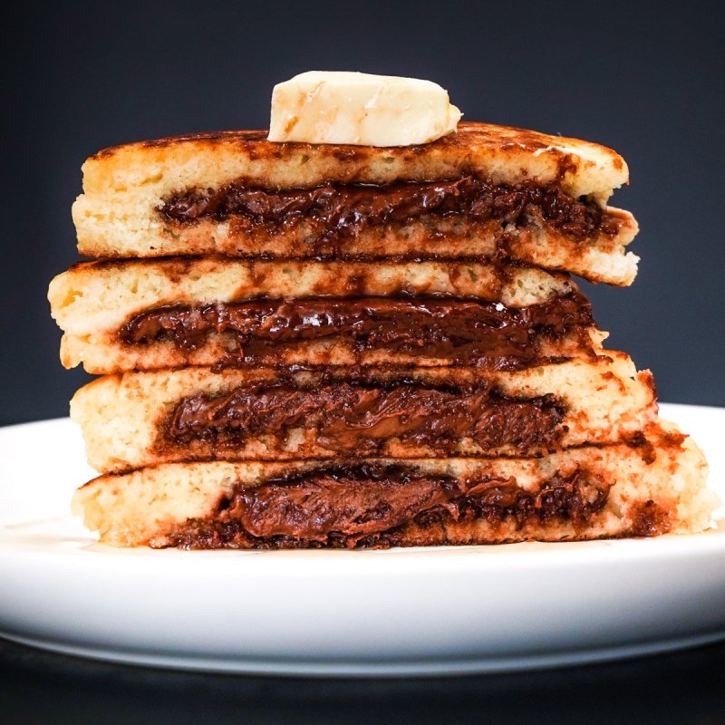 Pancake stuffed with Nutella open showing the filling.