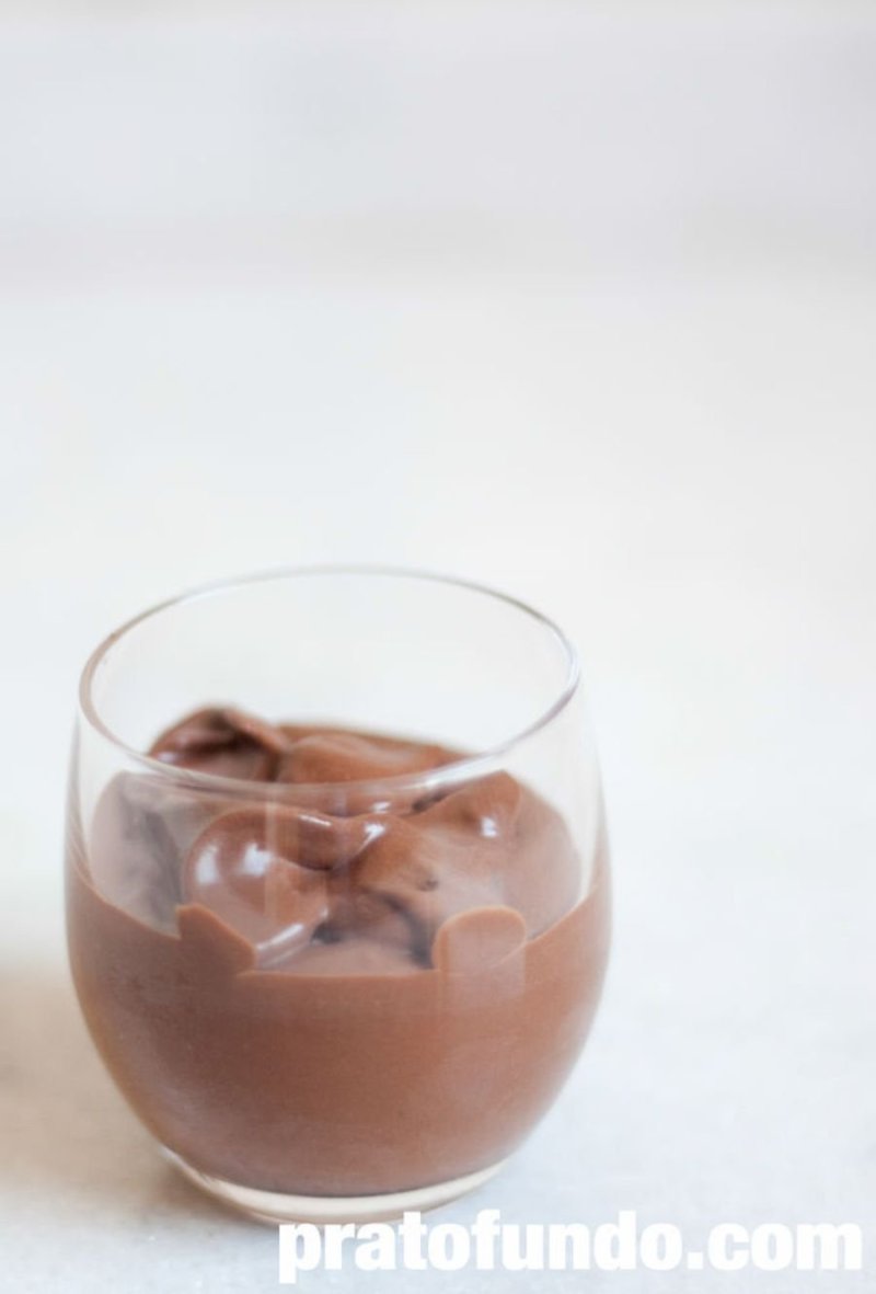 Chocolate mousse in a glass cup on a table