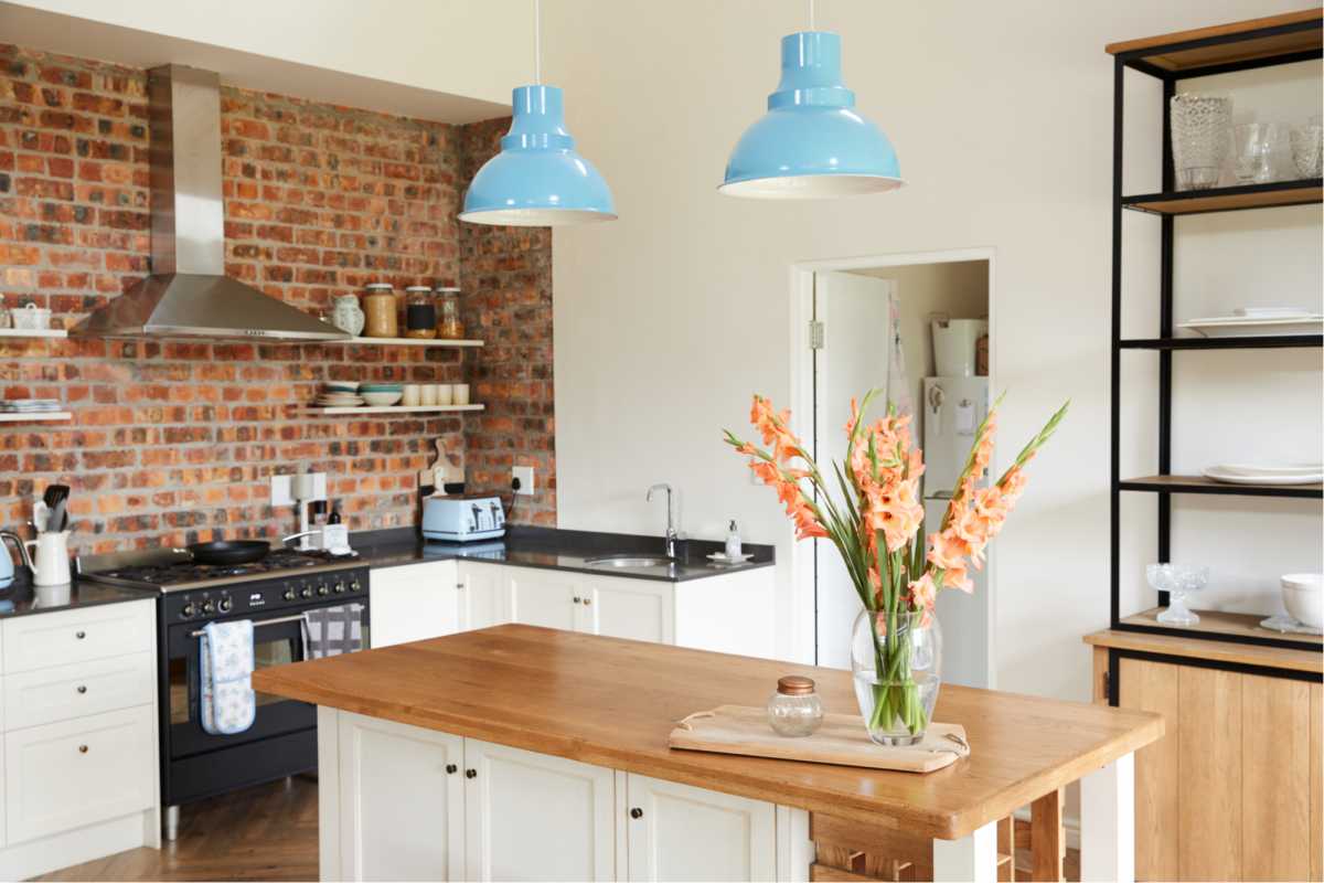 Kitchen with wooden details and blue light fixtures