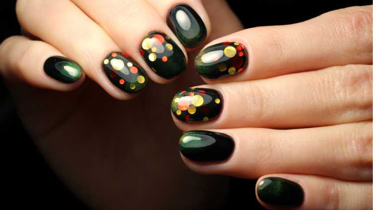 Black nail polish with colorful dots imitates confetti nail art