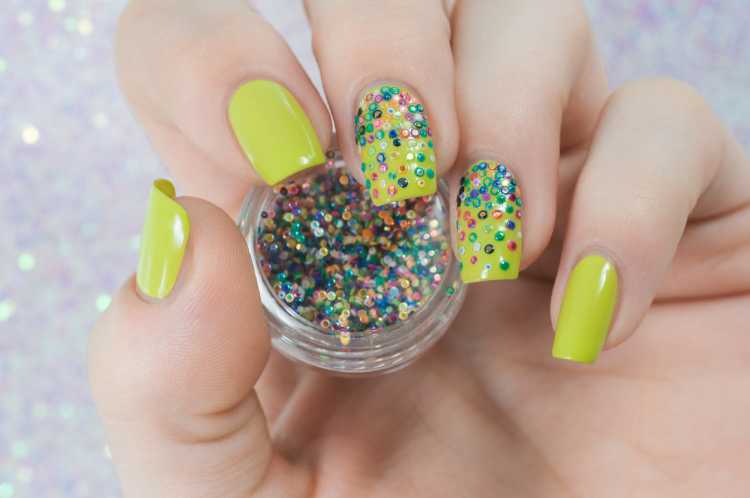 green nail polish with colorful beads imitates confetti nail art