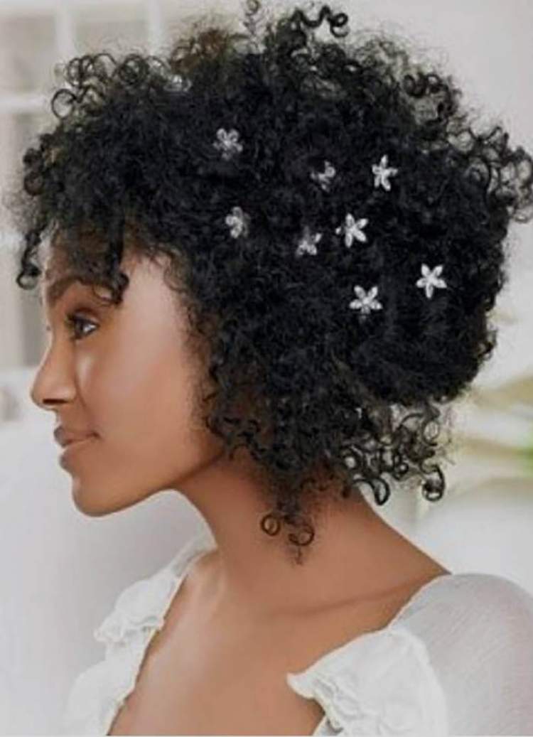 short, curly hair half up and with decorations