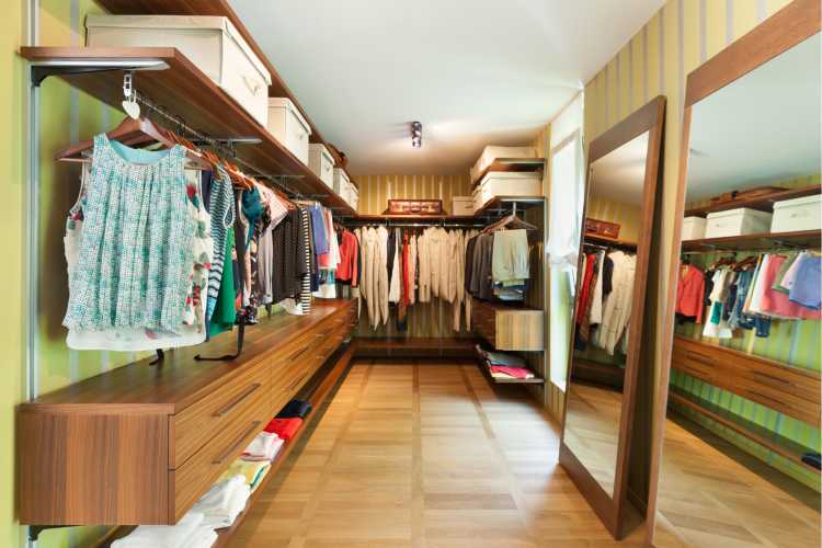 wooden closet with racks and mirror