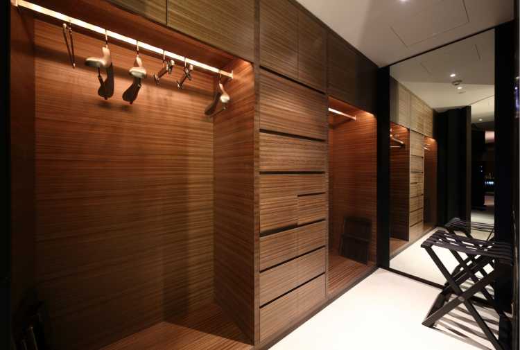 illuminated wooden closet with racks