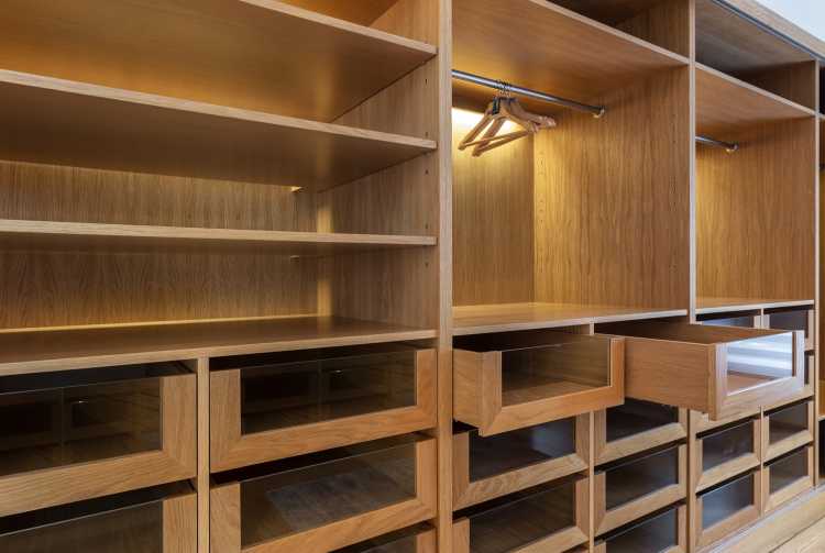 wooden closet with many drawers