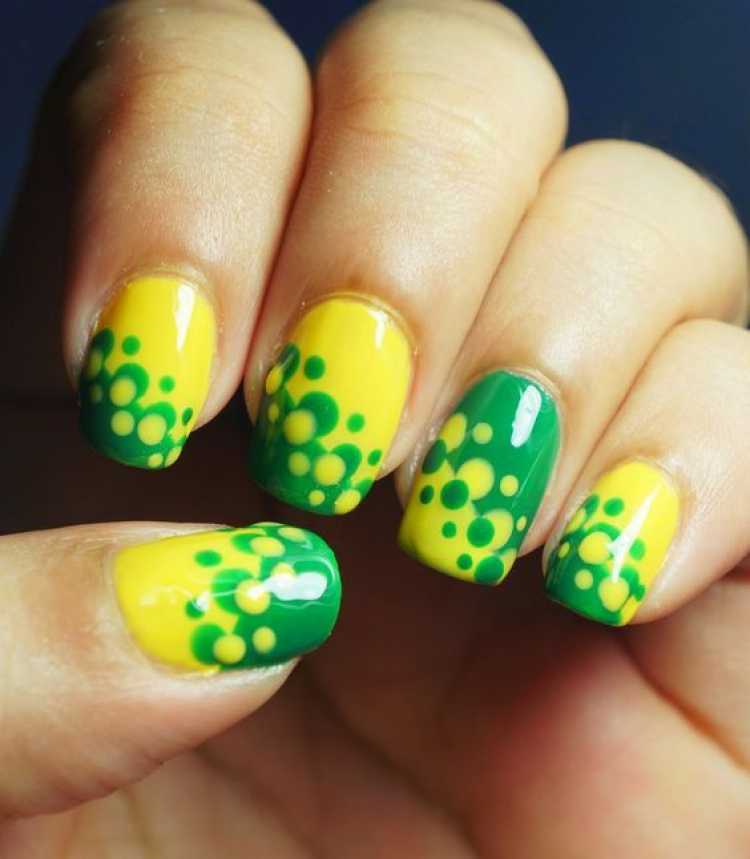 Nails decorated with green and yellow polka dots