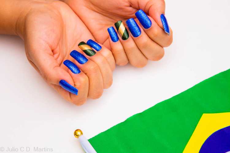 Very classic, blue nails look incredible on an only child with the colors of the Brazilian flag in glitter.