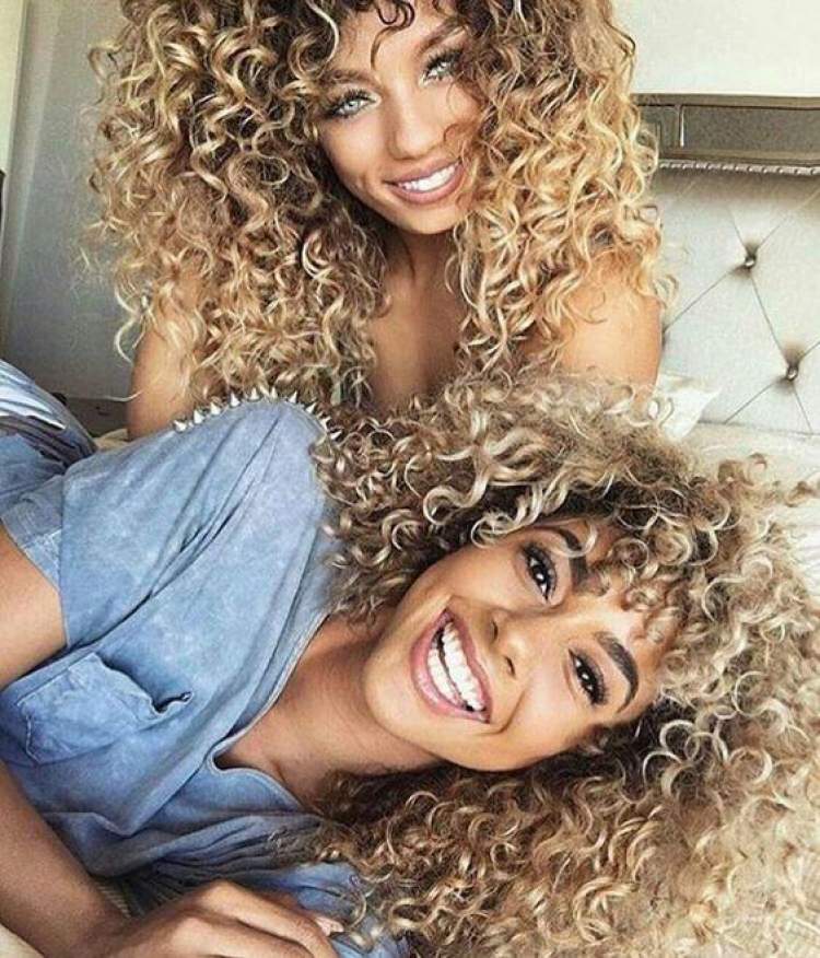 Blonde curly hair with dark roots