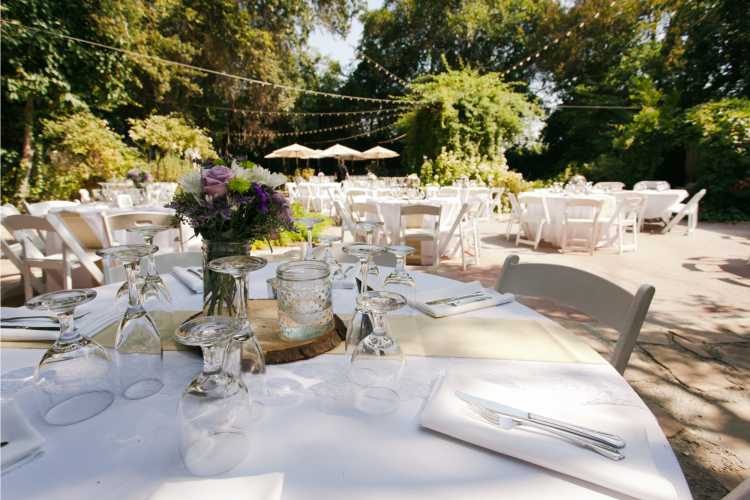 round tables decorated for wedding on the grass