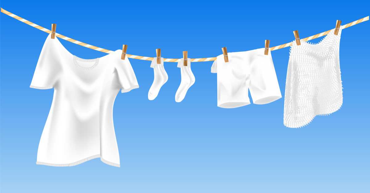 Clothesline with only white clothes drying outdoors