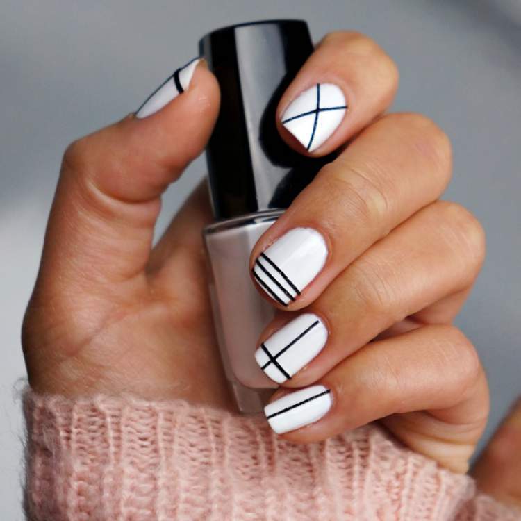 Nails decorated in black and white