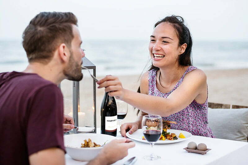 happy bride and groom having dinner 