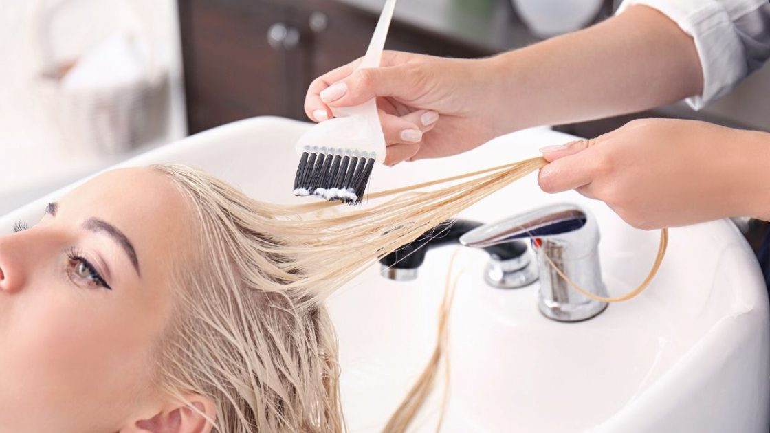 Woman in salon bleaching her hair