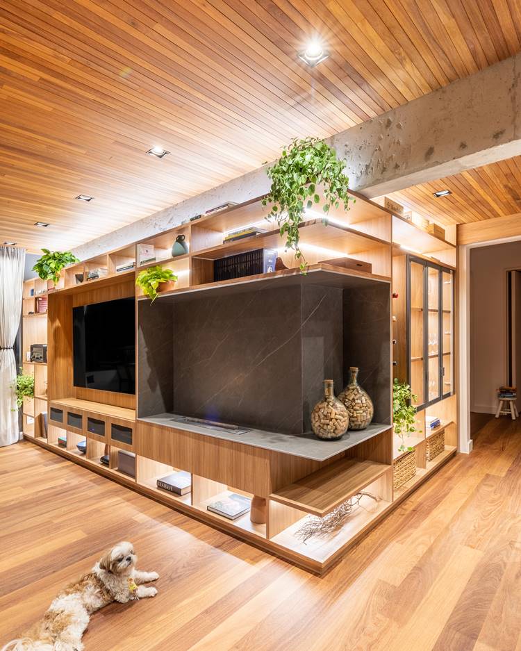 Fireplace in the home theater of the decorated 187 m² apartment.  Porcelain tile finish that imitates gray marble.  Furniture integrated with the kitchen cabinet.