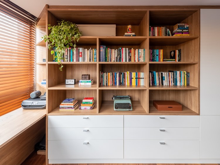 Home office furniture, with many books in the compartments, old typewriter, printer, boxes and drawers