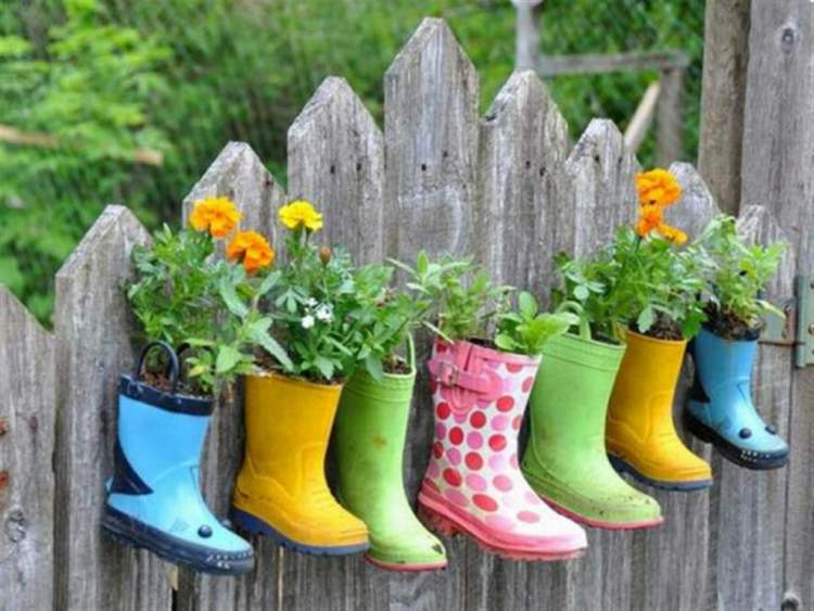 Vases with plants and flowers made with colorful galoshes