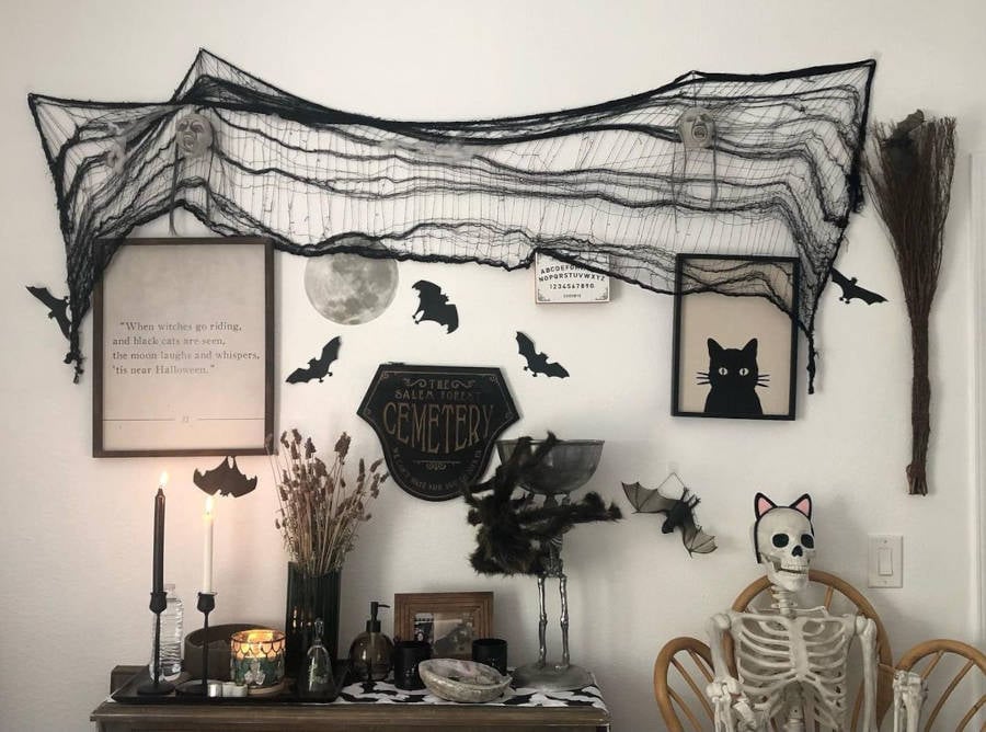 White wall with black halloween decorations.