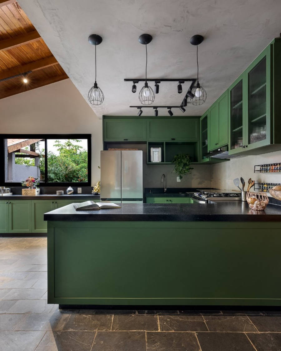 American kitchen with green and black cabinets.