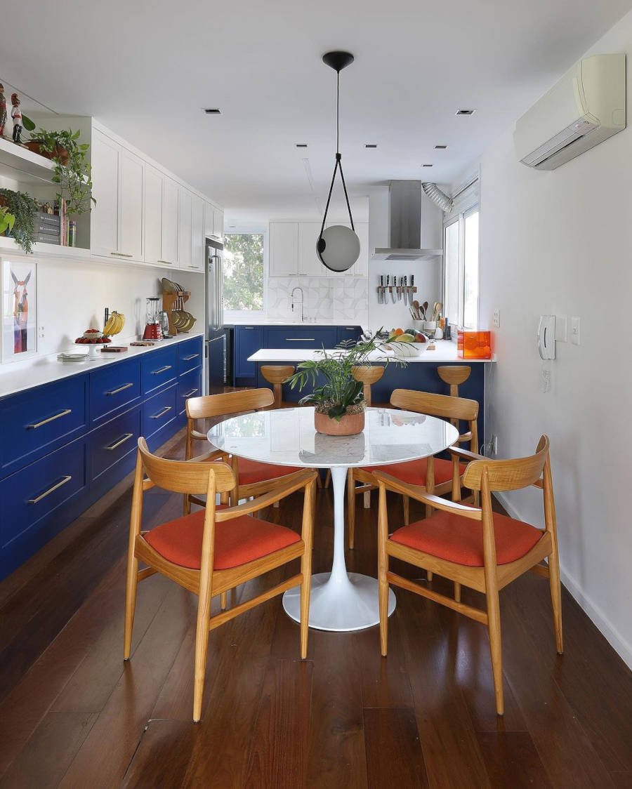 Small kitchen with round table.