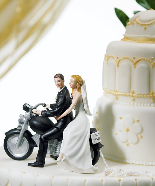 Bride and groom on top of wedding cake