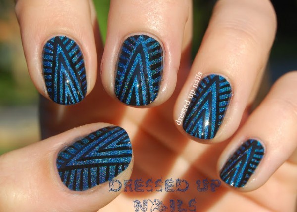 Nails decorated with ethnic designs in blue and black