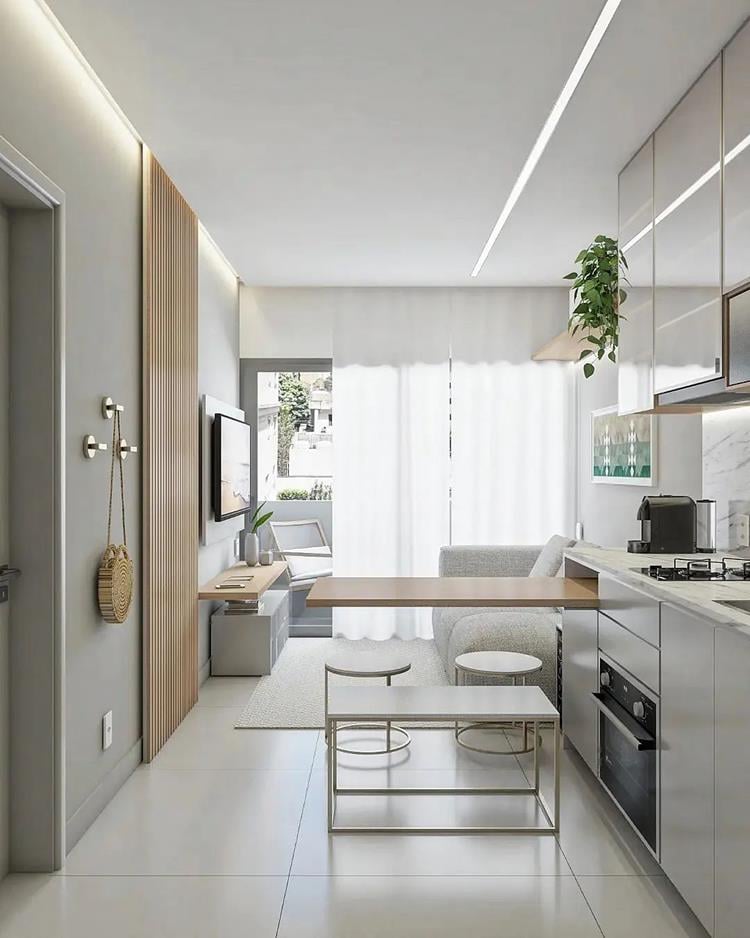 photo of integrated kitchen and living room in a small apartment in light tones