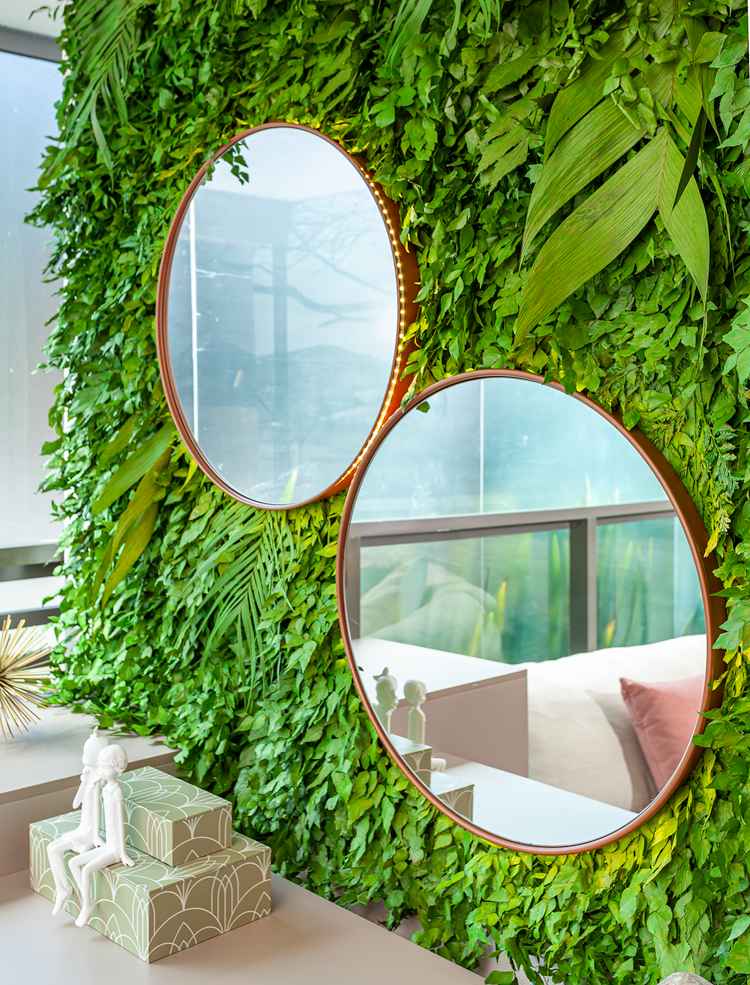 photo of two round mirrors leaning against a leaf wall