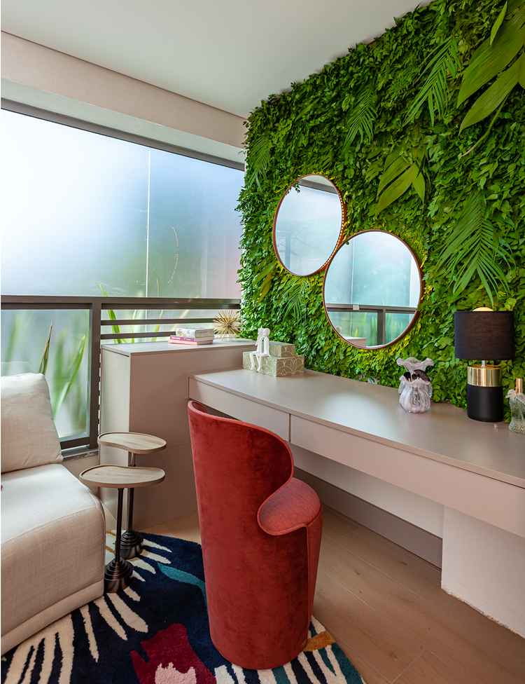 photo of white dressing table on the balcony with a wall of plants