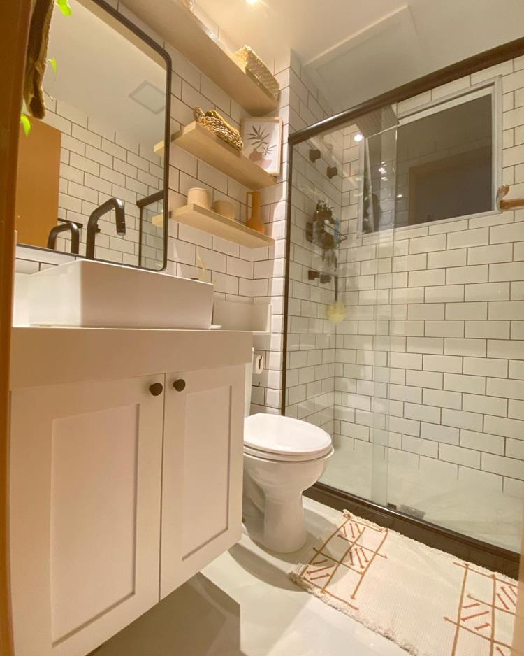 white bathroom with black grout and white furniture