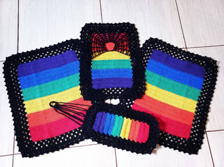 Crochet rug with the colors of the LGBTQIA+ flag.