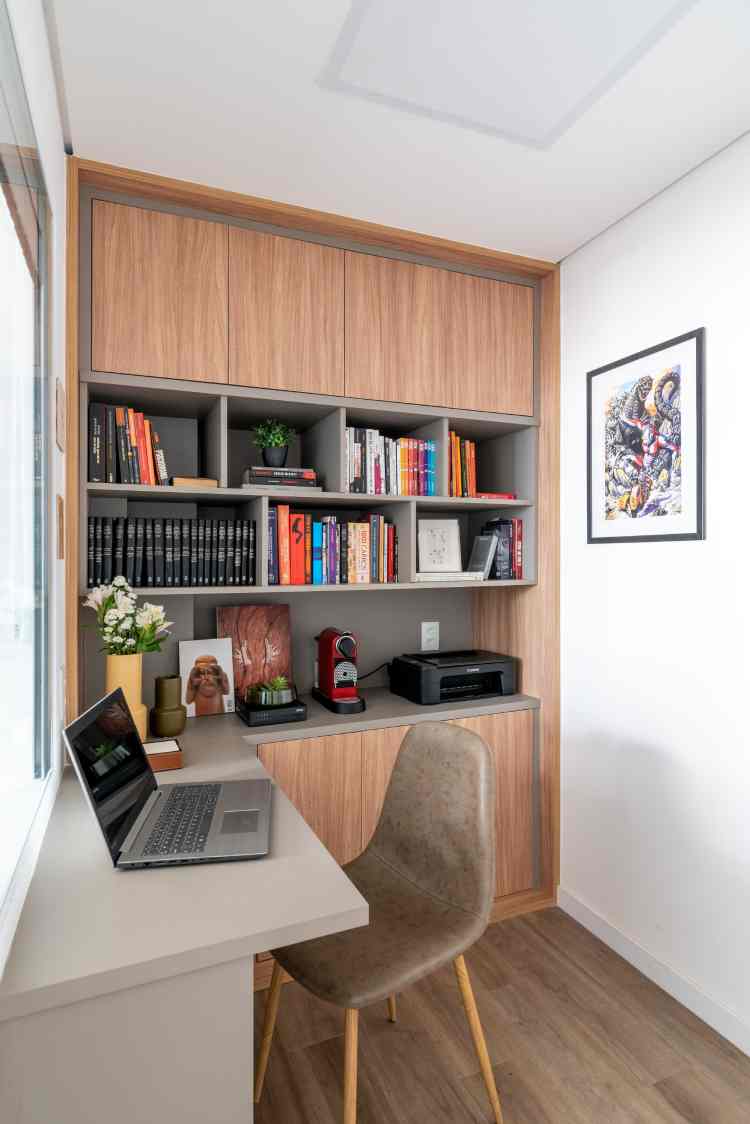 reading corner with wall of bookshelves and white desk next to it