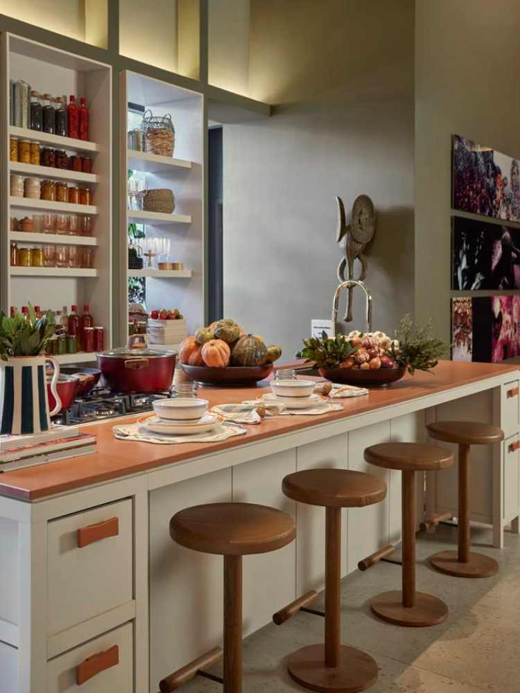 brown benches, white kitchen bench with wooden top and white shelves in the background