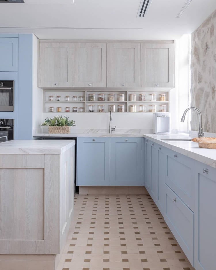 American kitchen with blue cabinets and porcelain tiles.