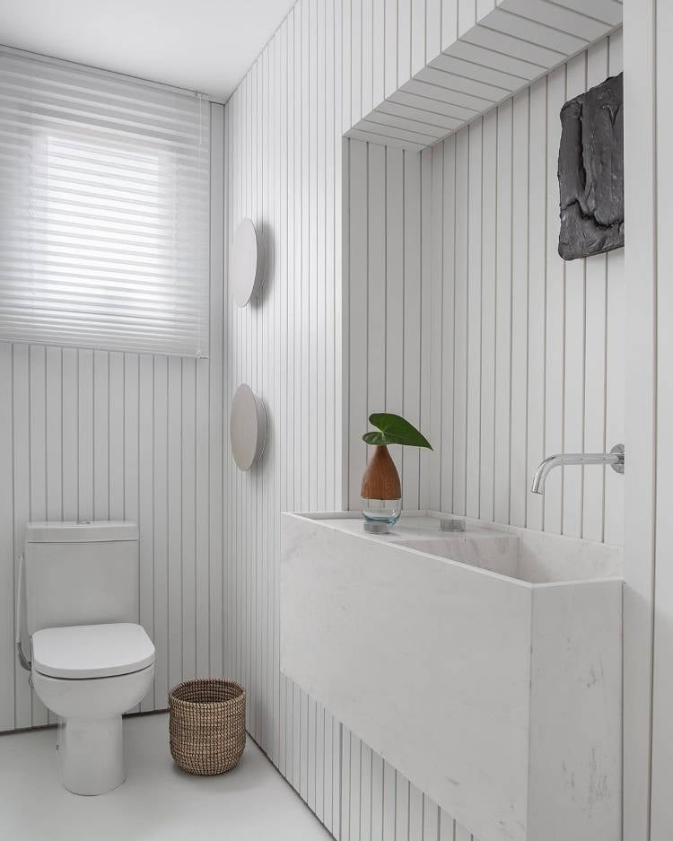 Toilet with texture on the wall.