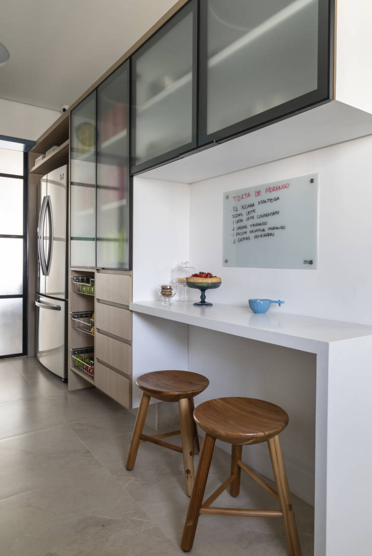 Large kitchen with corner for quick meals attached to the wall with low stools.