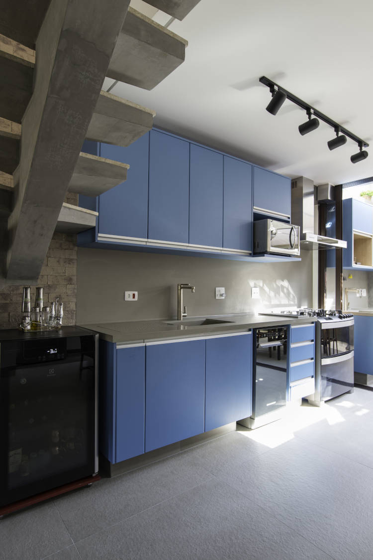 Industrial decor with blue kitchen.