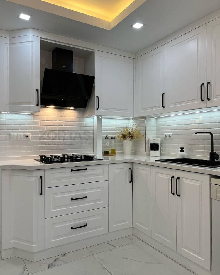 Small white kitchen with black details.