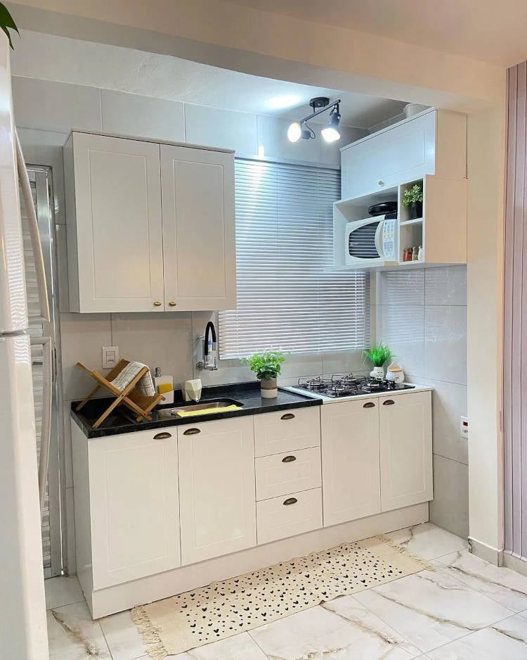 White mini kitchen with planned joinery.