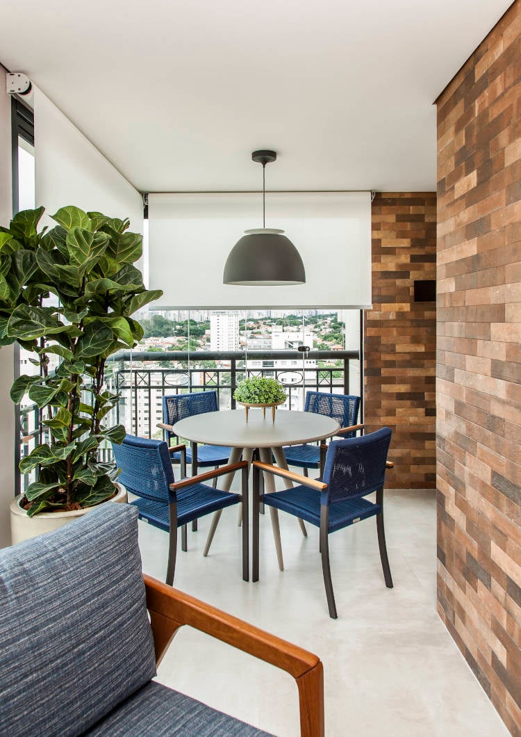 Dining table with blue chairs on the balcony.